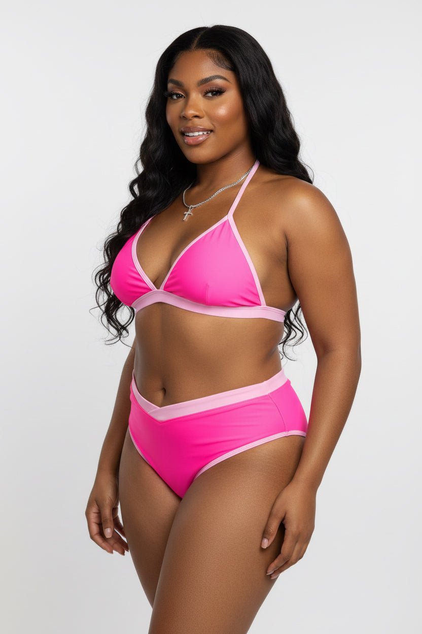 A woman modeling a two-piece bikini set in bright pink with light pink trim, photographed against a plain light gray studio background.